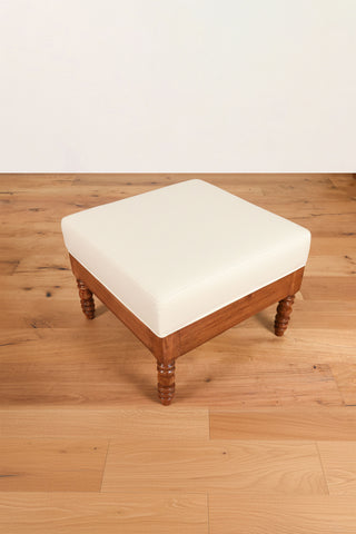 Beige velvet ottoman with turned teakwood legs and vintage design
