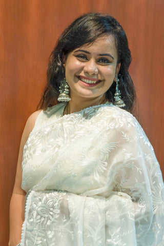 Pearl white pure silk organza saree with Parsi Gara floral and bird embroidery.