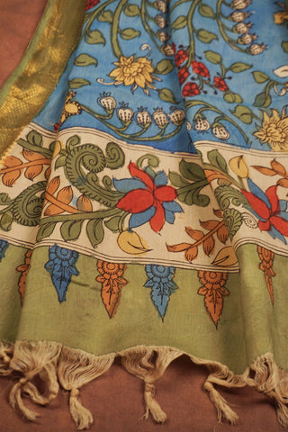 Sky blue Kalamkari saree with hand-painted floral vines, delicate gold zari border and hand-tied tassels