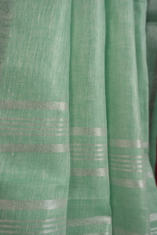 Pastel mint linen saree with magenta contrast border