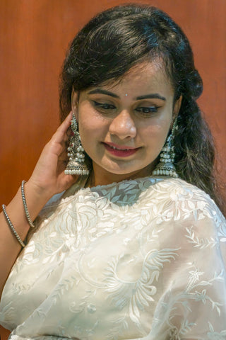 Pearl white pure silk organza saree with Parsi Gara floral and bird embroidery.