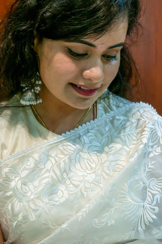 Pearl white pure silk organza saree with Parsi Gara floral and bird embroidery.