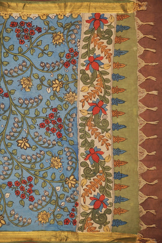 Sky blue Kalamkari saree with hand-painted floral vines, delicate gold zari border and hand-tied tassels