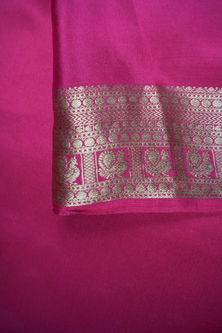 Black crepe silk saree with scattered gold peacock buttis, magenta pink border and zari striped pallu