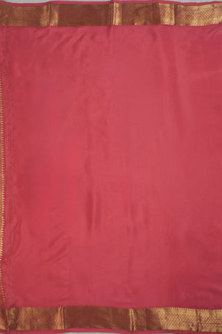 Ivory saree with gold zari checks, coral pink stripes and a triangular zari pattern leading into the pallu