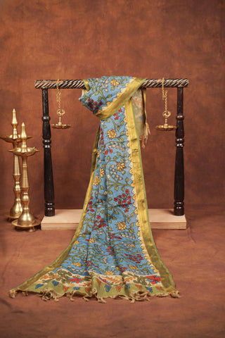 Sky blue Kalamkari saree with hand-painted floral vines, delicate gold zari border and hand-tied tassels