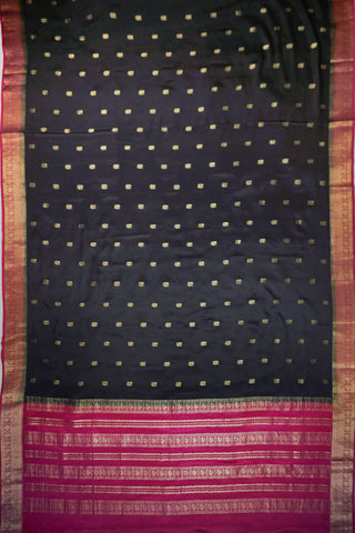 Black crepe silk saree with scattered gold peacock buttis, magenta pink border and zari striped pallu