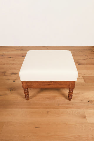 Beige velvet ottoman with turned teakwood legs and vintage design