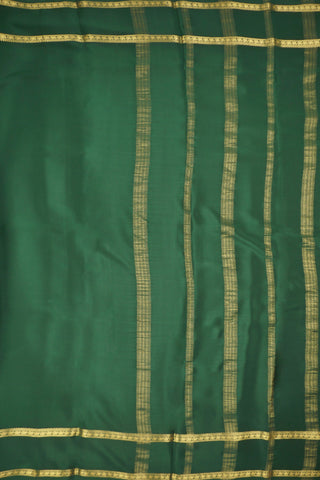 Bottle green crepe silk saree with paisley zari border