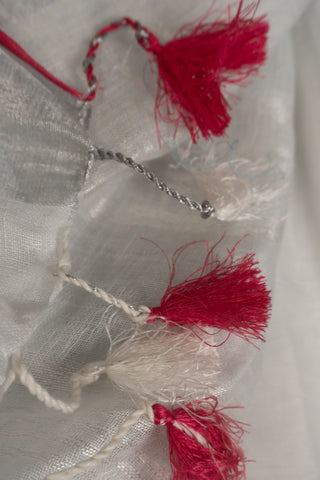 White linen saree with magenta border and tassels