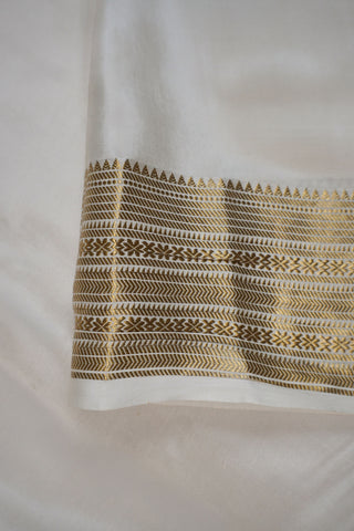 Maroon crepe silk saree with gold zari geometric border and an off-white pallu with vertical zari stripes