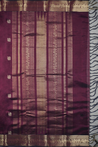 Deep aubergine pure silk saree with gold zari peacock motifs and elephant peacock striped pallu panels