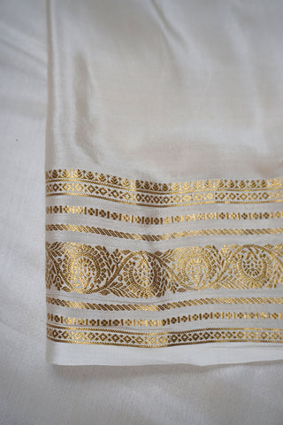 Pink crepe silk saree with fine gold checks, off-white paisley zari border and off-white striped pallu