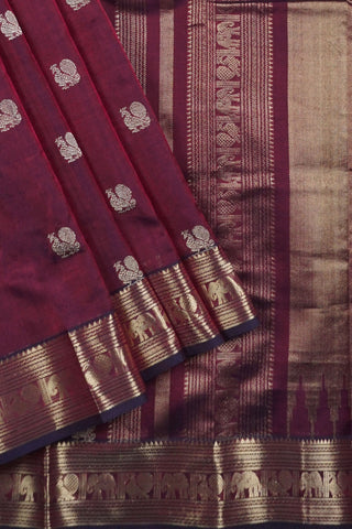 Deep aubergine pure silk saree with gold zari peacock motifs and elephant peacock striped pallu panels