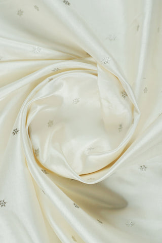 Off-white Paithani saree with silver zari stripes and a silver tissue pallu with a peacock and flower tree