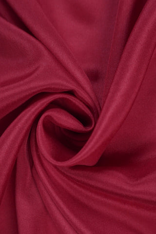 Maroon crepe silk saree with gold zari geometric border and an off-white pallu with vertical zari stripes