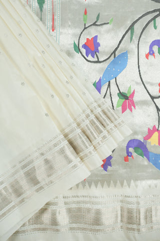 Off-white Paithani saree with silver zari stripes and a silver tissue pallu with a peacock and flower tree