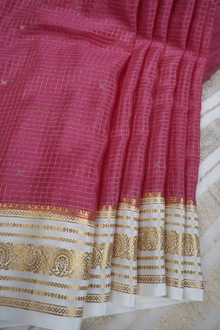 Pink crepe silk saree with fine gold checks, off-white paisley zari border and off-white striped pallu