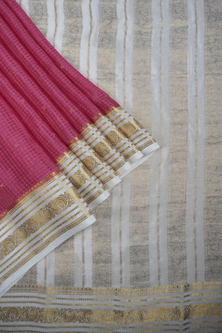 Pink crepe silk saree with fine gold checks, off-white paisley zari border and off-white striped pallu