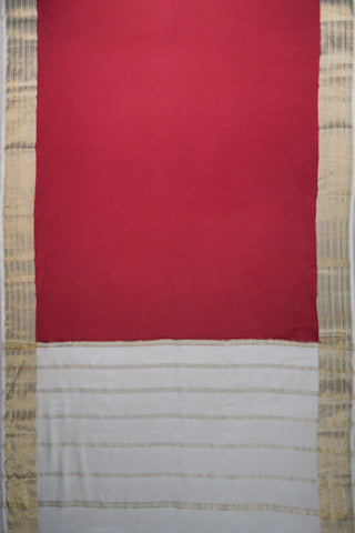 Maroon crepe silk saree with gold zari geometric border and an off-white pallu with vertical zari stripes