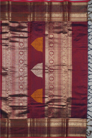 Rich wine and navy blue shot silk saree with gold zari elephant and peacock arch motifs on the pallu