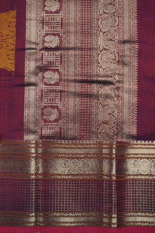 Rich wine and navy blue shot silk saree with gold zari elephant and peacock arch motifs on the pallu