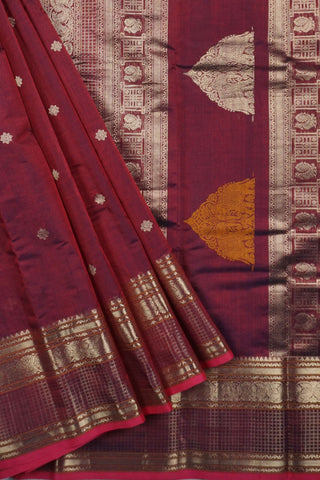 Rich wine and navy blue shot silk saree with gold zari elephant and peacock arch motifs on the pallu
