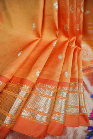 Orange Paithani silk saree with light gold buttis and a tissue pallu of circular chakra motifs with peacocks