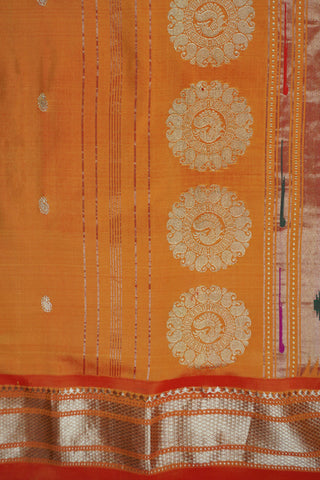 Orange Paithani silk saree with light gold buttis and a tissue pallu of circular chakra motifs with peacocks