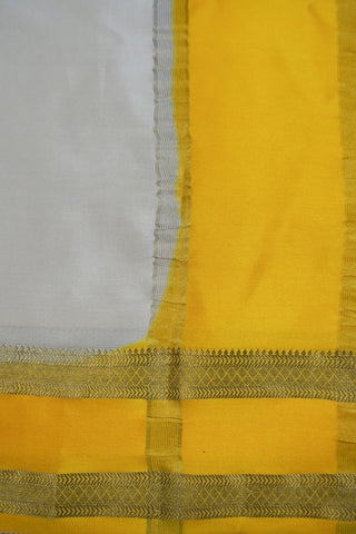 Draped off-white silk saree with a plain body, mustard yellow twin zari stripe border and yellow striped pallu