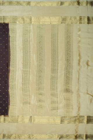 Coffee brown crepe silk saree with small gold floral buttas, paisley zari border and contrasting beige blouse