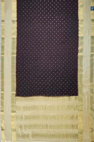 Coffee brown crepe silk saree with small gold floral buttas, paisley zari border and contrasting beige blouse