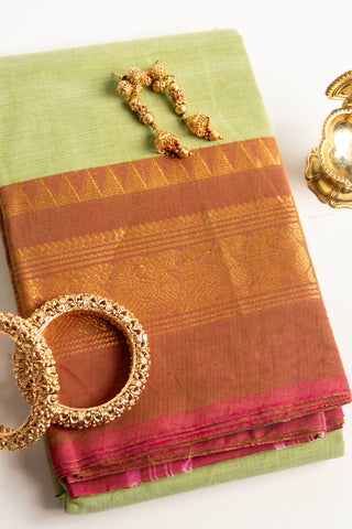 Pista green Chettinad cotton saree with rust-red and gold peacock border