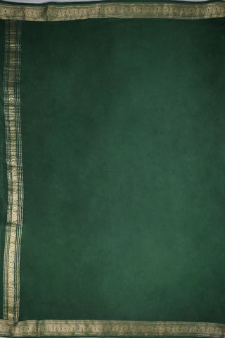 Mustard yellow silk saree with a bottle green border woven in gold zari floral and leaf motifs, striped pallu