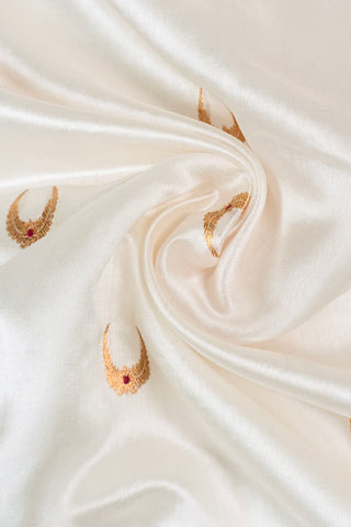 Off-white silk cotton Chanderi saree with gold zari chand motifs and red meenakari accents