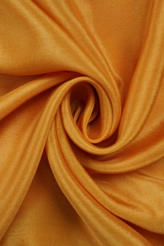 Mustard yellow silk saree with a bottle green border woven in gold zari floral and leaf motifs, striped pallu