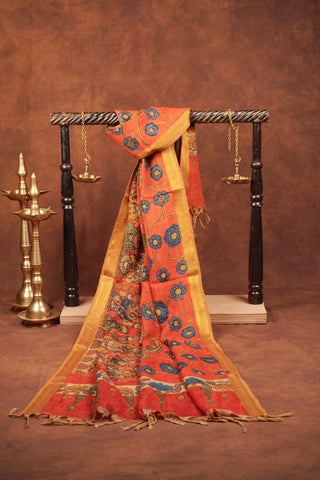 Rust orange Kalamkari saree with hand-painted floral vines, mythological figures and gold zari edging