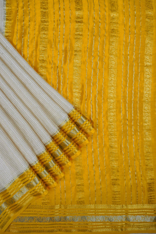 Off-white crepe silk saree with gold zari checks, mustard yellow paisley border and striped mustard pallu