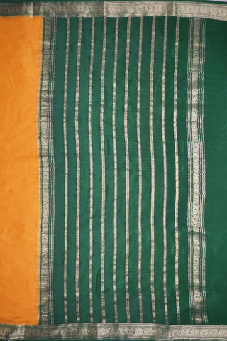Mustard yellow silk saree with a bottle green border woven in gold zari floral and leaf motifs, striped pallu