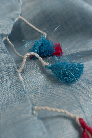 Pastel blue linen saree with contrast border and tassels