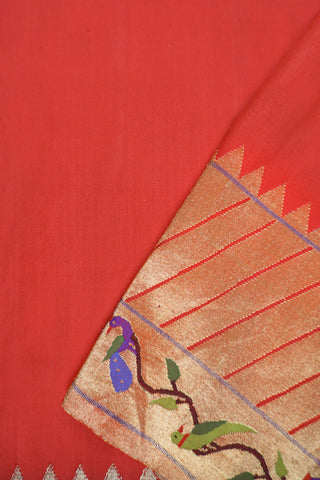 Red Paithani silk saree with gold buttis, tissue Muniya border and a pallu of parrots and peacocks on a tree