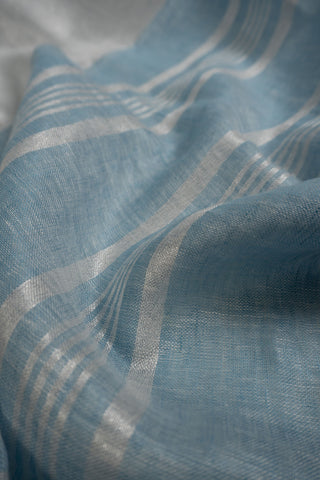 Pastel blue linen saree with contrast border and tassels