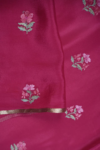 Lilac crepe silk saree with gold zari checks and pink, white and green floral vine embroidery on the borders