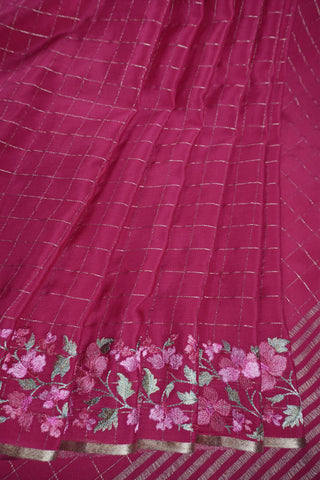 Lilac crepe silk saree with gold zari checks and pink, white and green floral vine embroidery on the borders