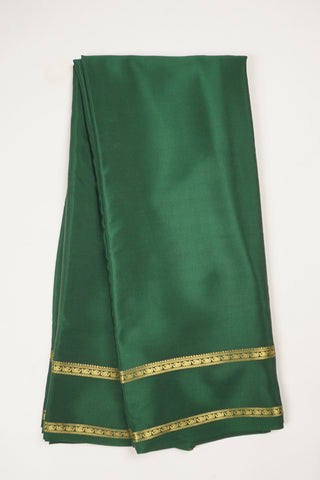 Bottle green crepe silk saree with paisley zari border