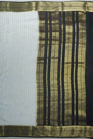 Ivory silk saree with gold pinstripes, a black zari lattice border with temple edges and a black striped pallu