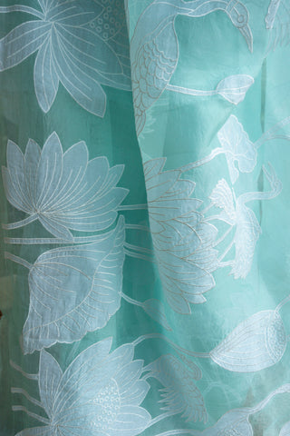 Mint green pure silk organza saree with floral and bird applique work.