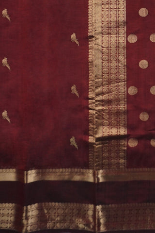 Deep maroon Kanchi silk saree with scattered gold zari bird motifs and a double Rettai Pattu border