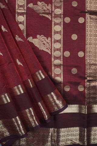 Deep maroon Kanchi silk saree with scattered gold zari bird motifs and a double Rettai Pattu border