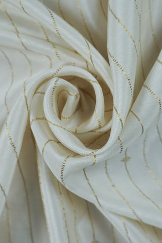 Ivory silk saree with gold pinstripes, a black zari lattice border with temple edges and a black striped pallu